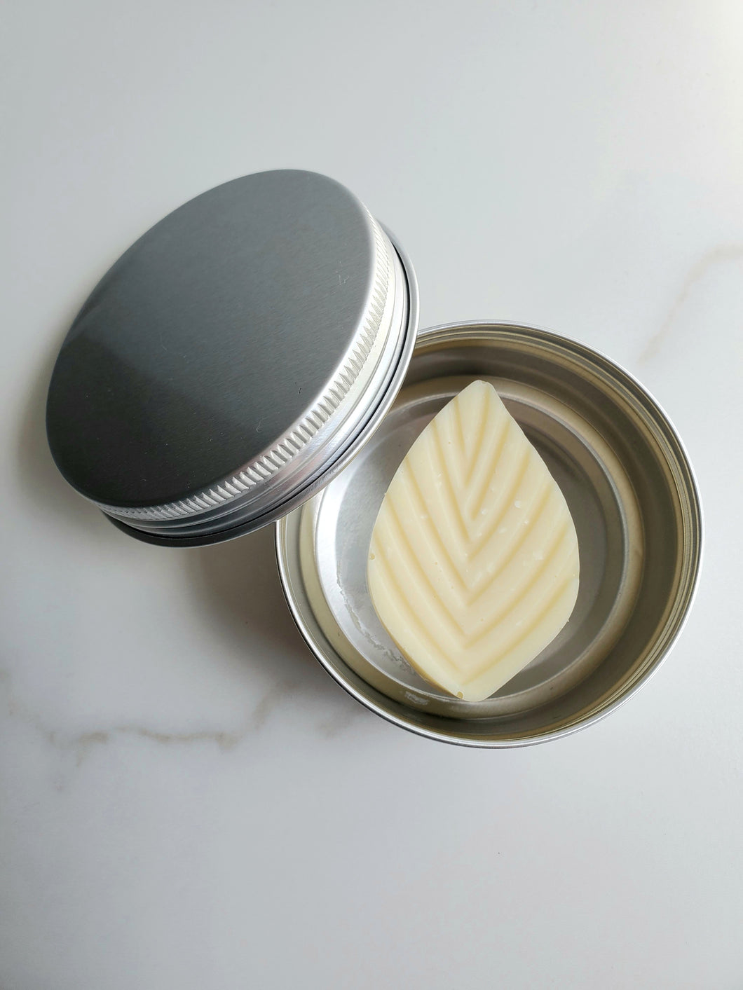 Solid lotion bar w/ tin